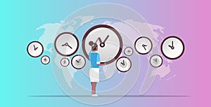 Businesswoman pointing on wall with clocks different cities time management deadline concept african ameriscan business