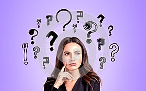 Businesswoman portrait with confused look, set of question marks