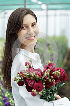 Businesswoman portrait holding a fresh flowers bouquet.