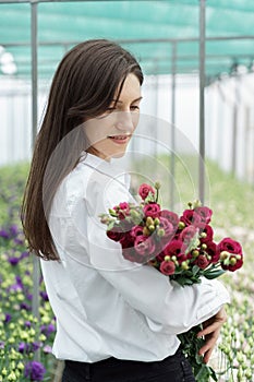 Businesswoman portrait holding a fresh flowers bouquet.