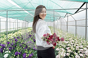 Businesswoman portrait holding a fresh flowers bouquet.