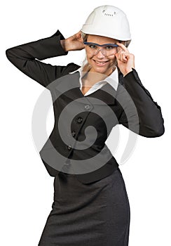 Businesswoman posing in hard hat and protective