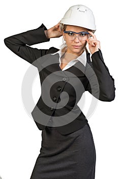 Businesswoman posing in hard hat and protective