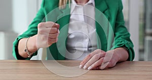 Businesswoman pounds fist on table to convey displeasure