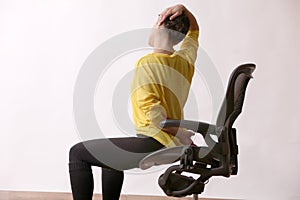 Businesswoman practices exercises at workplace