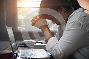 Businesswoman Praying with Eyes Closed. Businesswoman with her hands folded waiting for good news sitting at workplace at the