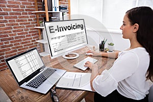 Businesswoman Preparing E-invoicing Bill On Computer