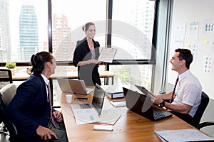 Businesswoman presentation to a group in meeting.