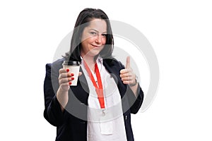 Businesswoman presenting coffee making thumb-up like gesture