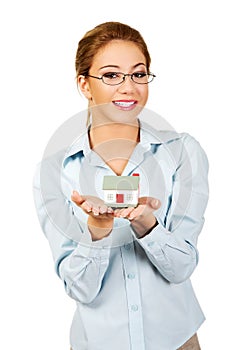 Businesswoman presenting a house model.