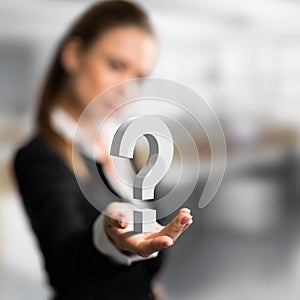 Businesswoman presenting a questionmark as symbol for a concern