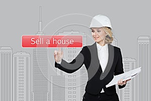 Businesswoman pressing sell a hause button on virtual screens