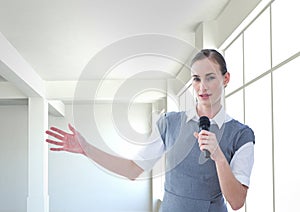 Businesswoman public speaking on microphone in office