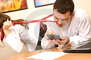 Businesswoman pulling her colleague tie