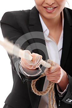 Businesswoman pulling on a piece of rope