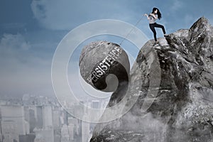 Businesswoman pulls persistence word on the cliff