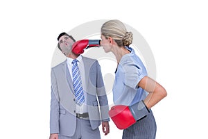 Businesswoman punching colleague with boxing gloves