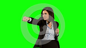 Businesswoman punching on green screen
