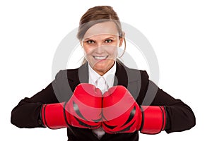 Businesswoman punching red boxing gloves together ready to fight