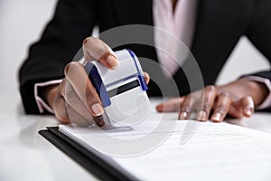 Businesswoman Putting Stamp On Documents