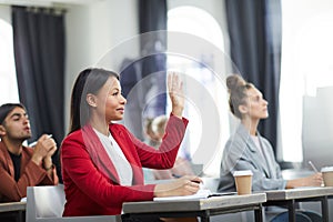 Businesswoman Raising Hand in Seminar