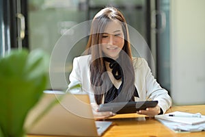 Businesswoman reading the email on her portable tablet