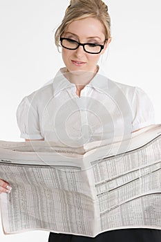 Businesswoman reading financial newspaper