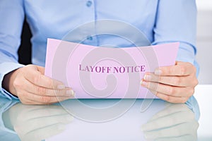 Businesswoman reading layoff notice