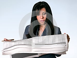 Businesswoman reading newspaper