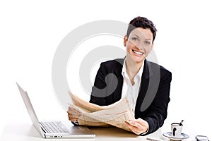 Businesswoman reading newspaper