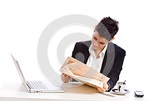 Businesswoman reading newspaper