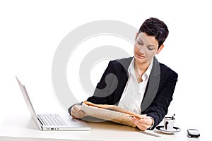 Businesswoman reading newspaper