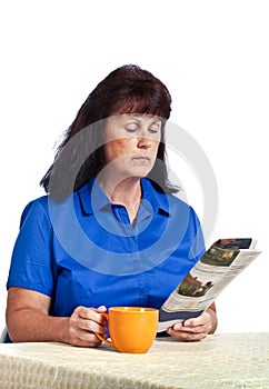 Businesswoman Reading Paper And Drinking Coffee