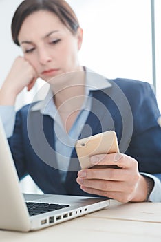 Businesswoman reading sms