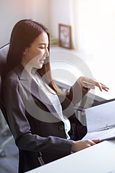 Businesswoman reading some informations on a folder binder