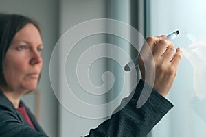 Businesswoman ready to write on office whiteboard