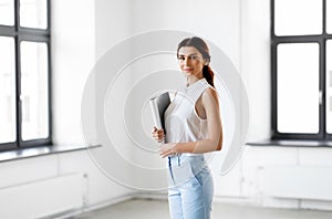 Businesswoman or realtor with folder at office