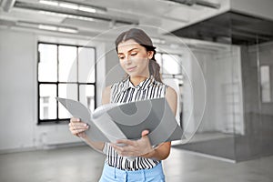 Businesswoman or realtor with folder at office