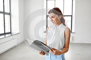 Businesswoman or realtor with folder at office