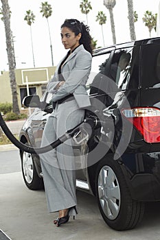 Businesswoman Refueling Car At Station