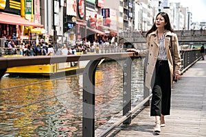 Businesswoman relaxing and walking beside river
