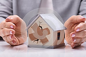 Businesswoman Protecting Broken House