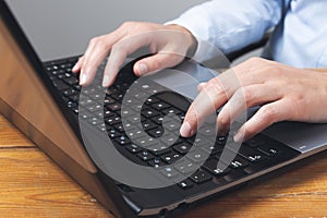 Businesswoman`s hands typing on laptop keybord photo