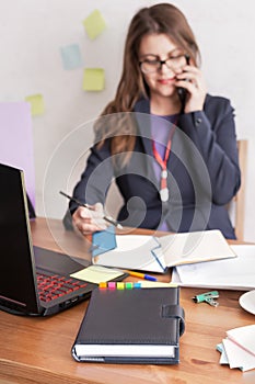 A businesswoman`s daily planner with a blurry human background