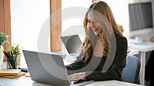 Businesswoman or secretary working on her notebook laptop computer