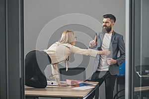 Businesswoman seducing boss man at office table