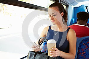 Businesswoman Sending Text Message On Bus photo