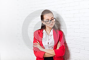 Businesswoman serious upset look down ponder wear red jacket glasses thinking