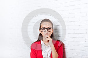 Businesswoman serious wear red jacket glasses hold chin ponder