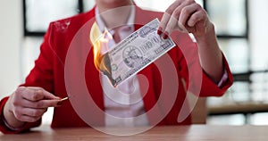 Businesswoman sets million dollar bill on fire with match